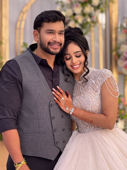 A sweet, romantic moment between the bride and groom. Her makeup looks soft and beautiful in this candid shot.