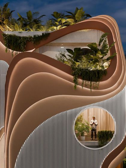 Another view of the illuminated facade, showing how the building transforms into a glowing sculpture after dark.