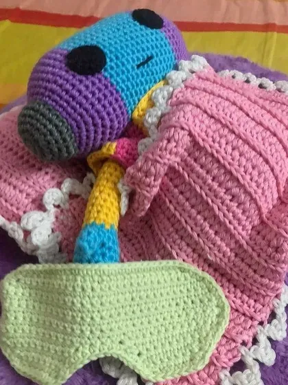 This is Zeno from Dragon Ball Z, tucked in for a nap. A client requested him with a custom-made blanket, pillow, and even a tiny sleep mask.