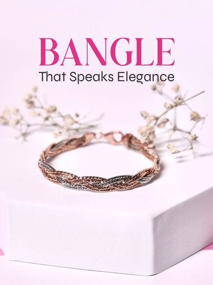 Grace your wrists with this timelessly elegant braided bangle, a beautiful blend of rose gold and silver tones.