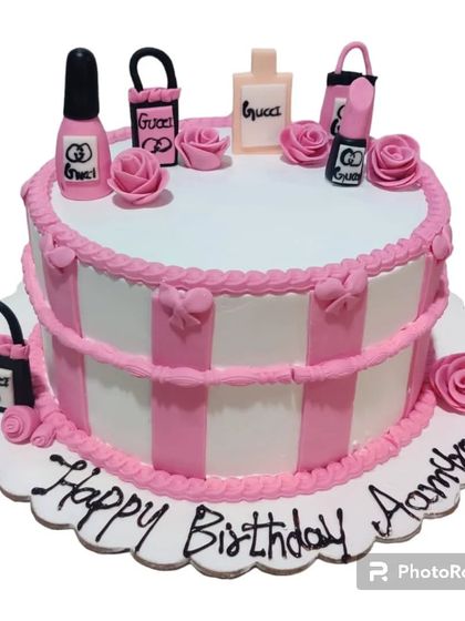 A chic makeup-themed cake for a beauty lover. This design is adorned with edible Gucci shopping bags, lipstick, and nail polish bottles.