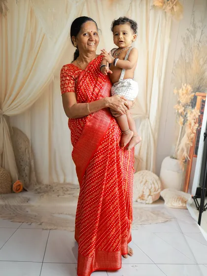 The bond between a grandmother and her grandchild is so precious. Here, she holds her grandbaby during a maternity session for her daughter, a beautiful multi-generational moment.