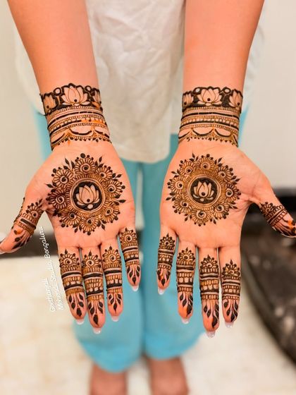 A classic and elegant minimal design. This features a lotus mandala on the palm with detailed work on the fingers and a simple wristband.