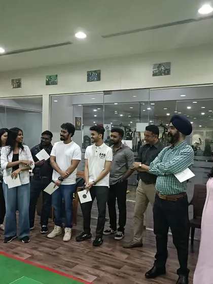 Laughter and learning go hand in hand during our corporate events. Here, a team shares a lighthearted moment while receiving their participation certificates, concluding a day of friendly competition and skill building.