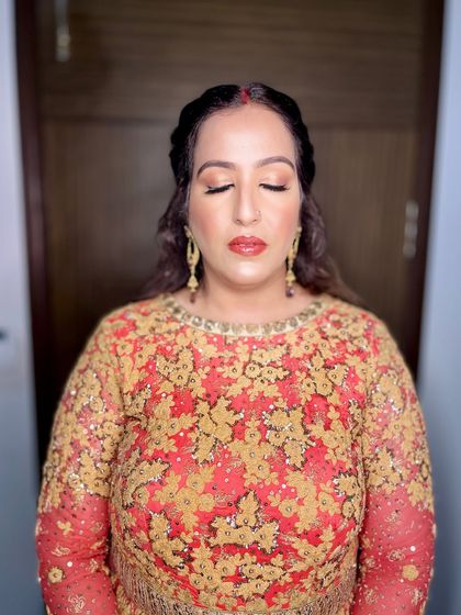 A close-up of the eye makeup, featuring warm, golden tones.