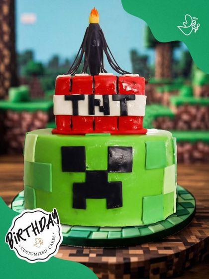 An explosive Minecraft TNT cake. This two-tier design features a Creeper face and a TNT block on top, ready to make the birthday a total blast.