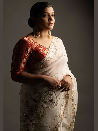 A portrait of Aparna Balamurali from our shoot. The combination of the red brocade blouse with the embroidered white saree created a look of classic elegance.