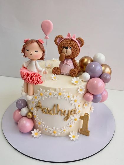 Another angle of the first birthday cake, highlighting the soft colors and handcrafted elements that make it so special.