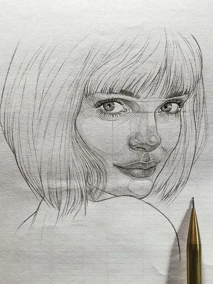 A close-up of the girl's portrait, showing the pencil used for the sketch. It's a simple tool, but capable of creating so much beauty.