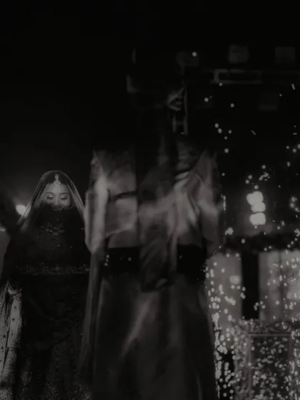 An artistic, moody black and white shot of the couple on stage, with a sense of mystery and drama.