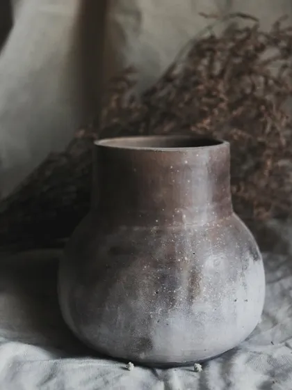 I call this pit-fired vase 'Stardust'. I achieved this subtle, speckled effect by throwing sawdust onto the piece when it was still hot from the fire. It’s a beautiful, earthy piece for dry arrangements.