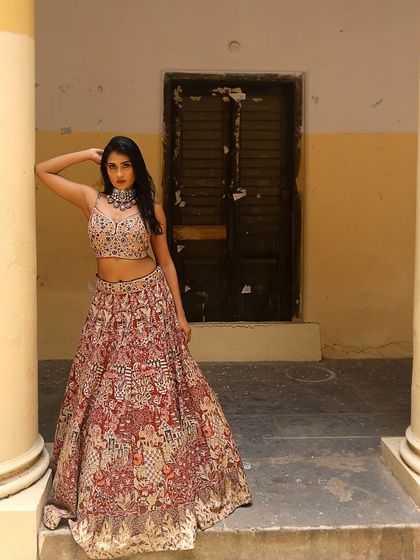 A full-length shot of Poornima, showcasing the entire lehenga and her confident pose. The look is perfect for an editorial or fashion shoot.