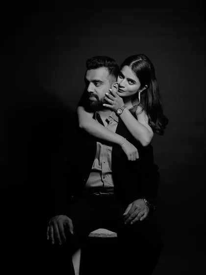 A sensual and moody black and white portrait. The bride's embrace from behind and the intense gaze create a powerful and intimate photograph.