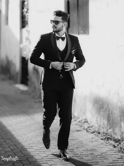 A groom's portrait should be all about confidence and style. I shot this in black and white to emphasize the sharp lines of the suit and the dynamic movement, creating a classic, cinematic feel as he walks through the historic lanes.