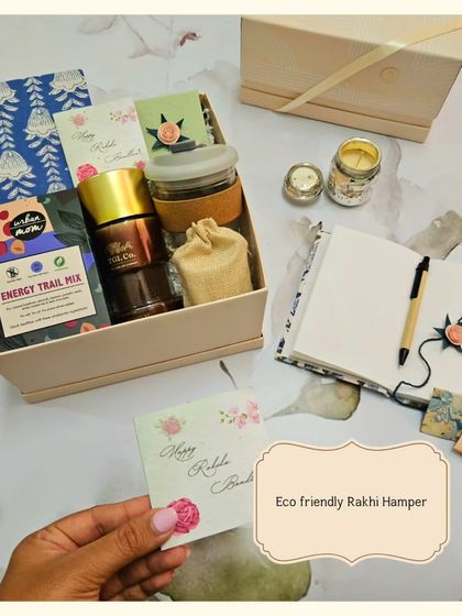 This eco-friendly Rakhi hamper combines tradition with a modern, sustainable touch. It includes sweet treats, a beautiful Rakhi, and a protective Evil Eye Roli Chawal set.