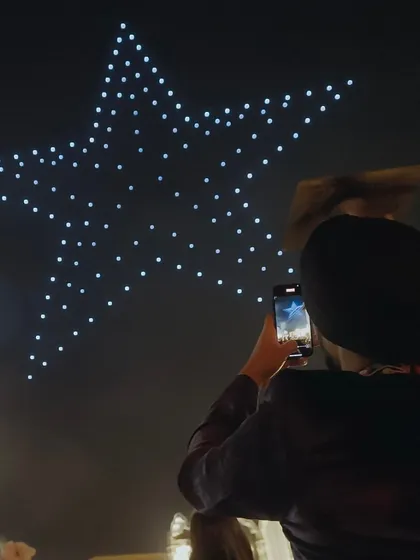 Say ‘I do’ to an unforgettable wedding experience. A guest captures a star formation at a wedding, showcasing how our drone shows can make a big day truly extraordinary.