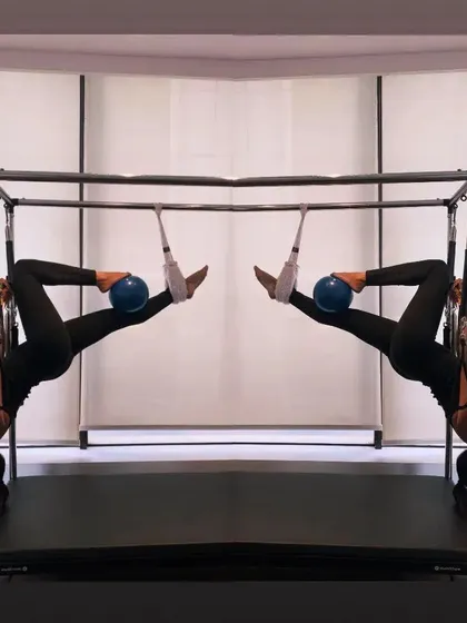 A mirrored image of a hanging inversion, highlighting the symmetry and balance we strive for in Pilates.