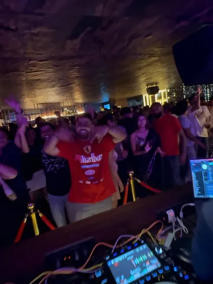 A guest having the time of his life right in front of the DJ booth at Kaze.
