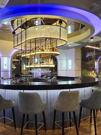The central bar at the Novotel in Guwahati, designed to be the heart of the hotel's social space. We used a combination of ambient and feature lighting, including a custom-designed circular chandelier, to create a sophisticated and welcoming atmosphere for guests.