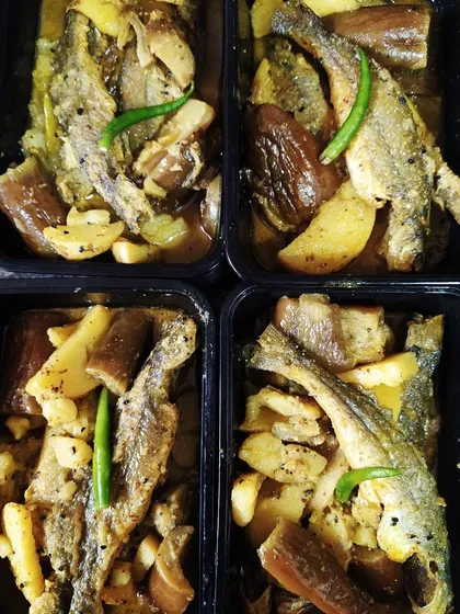 Here are portions of my rustic Tangra maach curry packed and ready for delivery. The fresh catfish, potatoes, and brinjals are cooked in a spicy mustard gravy, a favorite among my patrons.