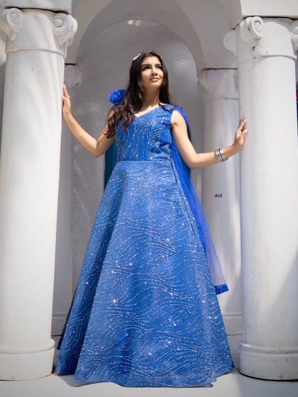 A full-length shot that shows how the complete look comes together. The makeup stands out even from a distance, defining the model's features and adding to the overall regal feel of the photograph.