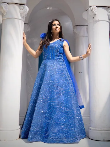 A full-length shot that shows how the complete look comes together. The makeup stands out even from a distance, defining the model's features and adding to the overall regal feel of the photograph.