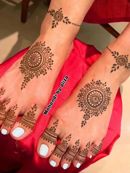 Minimal bridal feet design with a central mandala and simple patterns on the toes and ankles.