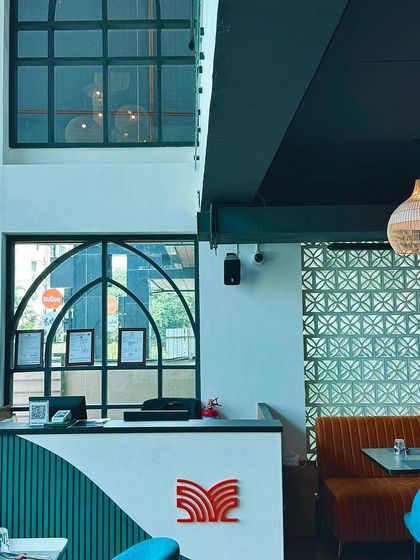 The high ceilings and large, arched windows at our entrance create a sense of openness and light, welcoming guests into our sophisticated space.