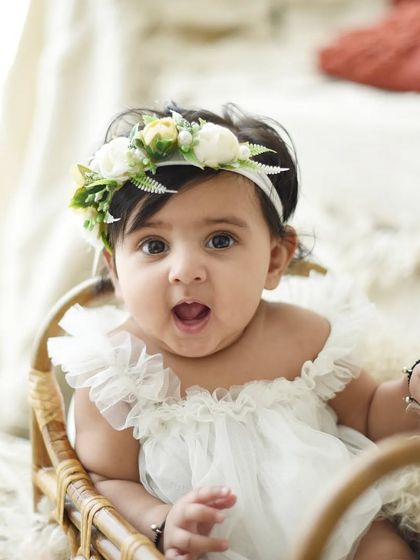The look of surprise and wonder is priceless. At six months, babies are so expressive, and I love capturing all their different faces. This simple, bright setup keeps the focus on her.