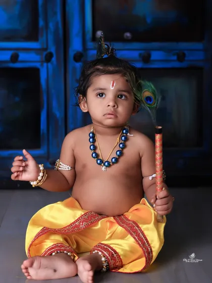 We celebrate culture and tradition with our special themed photoshoots. This adorable 'Little Krishna' session for Janmashtami uses authentic costumes and props to create a divine and heartwarming portrait of your child.
