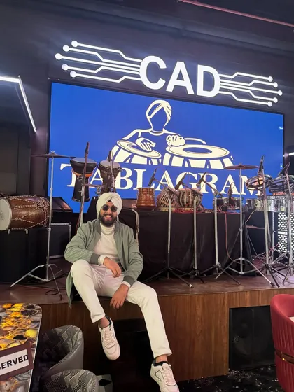 Posing at my performance station at CAD Noida. The custom "Tablagram" visuals on the screen are part of the complete show package.