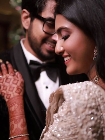 A duplicate of 308, this romantic close-up highlights the bride's smile and her beautiful henna.