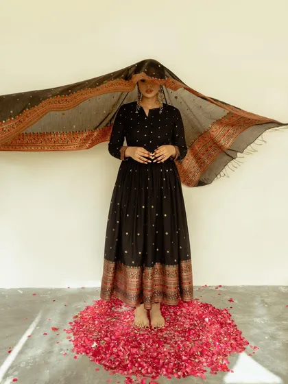 A dynamic shot for Safaa World, capturing the model as she arranges a flowing dupatta. The composition is elegant and highlights the beauty of the traditional garment.