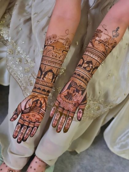 A beautiful shot of a bride's hands and feet, with the hands featuring full-arm traditional mehandi.