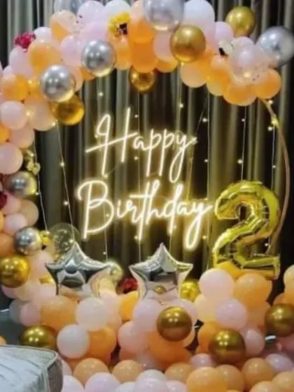 A beautiful ring decoration for a 21st birthday, using peach, white, and gold balloons.