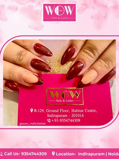 A bold and artistic design on long, almond-shaped extensions. This look combines a deep burgundy with a neutral accent nail, creating a modern and sophisticated contrast.