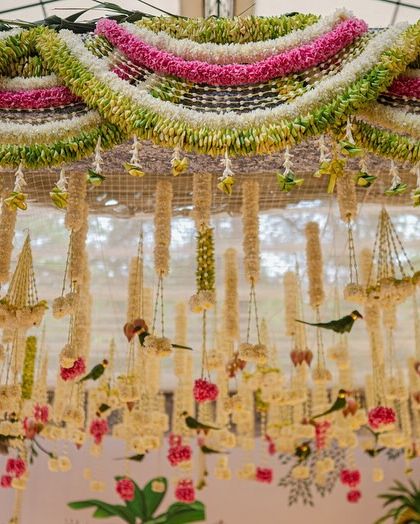 A close-up of the floral ceiling, showing the delicate parrot figures nestled among the flowers. These small, handcrafted details are a testament to our commitment to creating unique and personalized decor.
