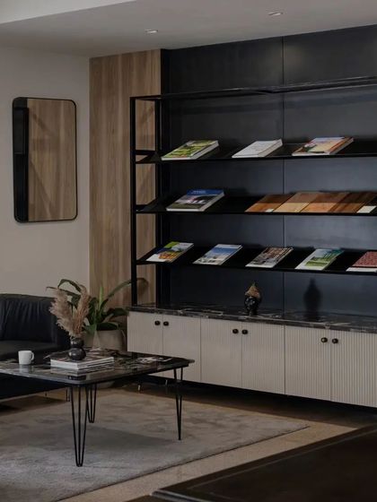 The client meeting area in my studio, featuring the custom-designed material display rack. The space is designed to be comfortable and inspiring, with a mix of textures like fluted wood, marble, and metal, allowing clients to see and feel the quality of materials I work with.