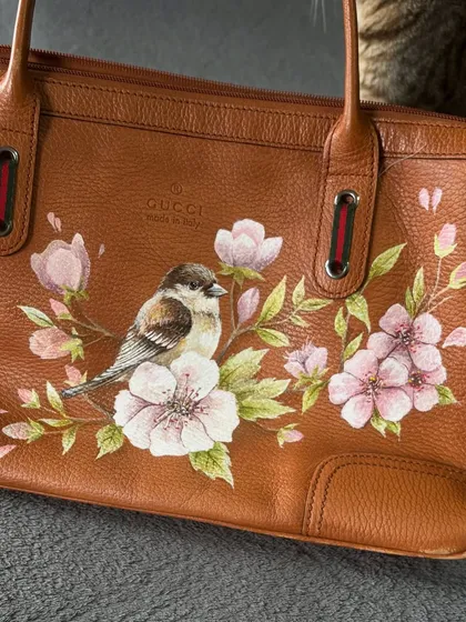A close-up of the bird and blossoms. I use fine brushes and high-quality paints to achieve this level of realism on leather.