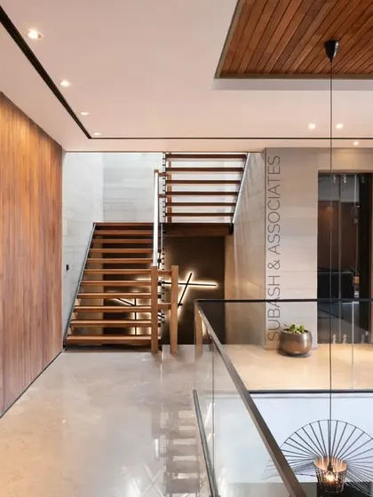 This view from the first floor showcases the home's consistent material palette of wood, tile, and stone, which unifies the common spaces.