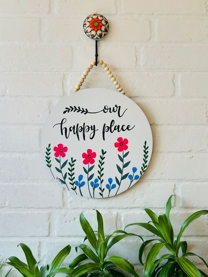 Our 'Our Happy Place' wooden sign is a must-have for any home. The hand-doodled flowers and beautiful calligraphy make this a charming and welcoming piece for your entrance.