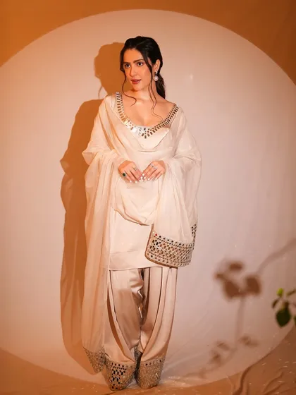 Another angle of this classic look, showing the beautiful mirror work on the outfit. The makeup remains timeless and elegant from every view.