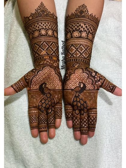 This design showcases majestic peacocks on the palms, with their feathers created from fine, detailed linework. The arms feature classic checkerboard and geometric patterns for a balanced look.