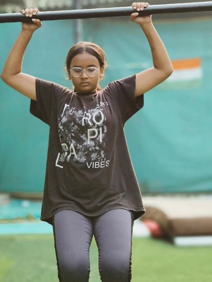 Working on her pull-up strength. This foundational exercise is key to unlocking many other calisthenics skills.
