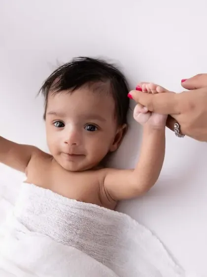 A tiny, trusting hand grasping onto a parent's finger. This is another one of those powerful detail shots that tells a story of love and connection.