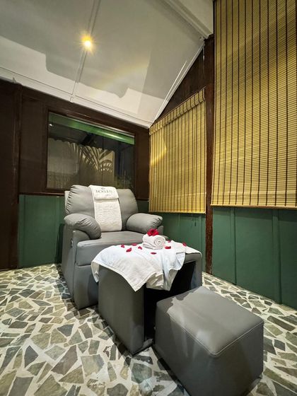A wider view of our foot therapy station at the Iosis Luxe Wellness Centre in Guwahati. The combination of natural textures like stone and bamboo creates a grounded, earthy atmosphere for your treatment.
