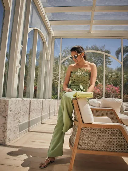 A relaxed pose in the Oscar de la Renta outfit, perfect for a stylish daytime event or a luxury vacation.