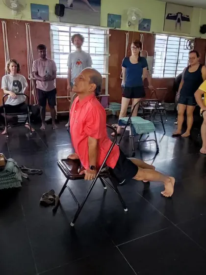 An upward-facing dog variation on a chair.