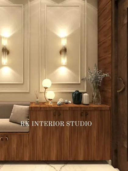 Another foyer concept, this one featuring a wooden shoe cabinet with an attached seating bench. The elegant wall mouldings and decorative lamps create a warm and sophisticated welcome.