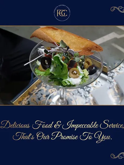 A sophisticated Greek salad served in a wine glass with a toasted crouton. This presentation style allows guests to enjoy a fresh salad without the need for a table setting.